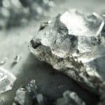 The Scandium has a soft, silvery-white appearance with hints of a yellowish or pinkish cast from oxidation.