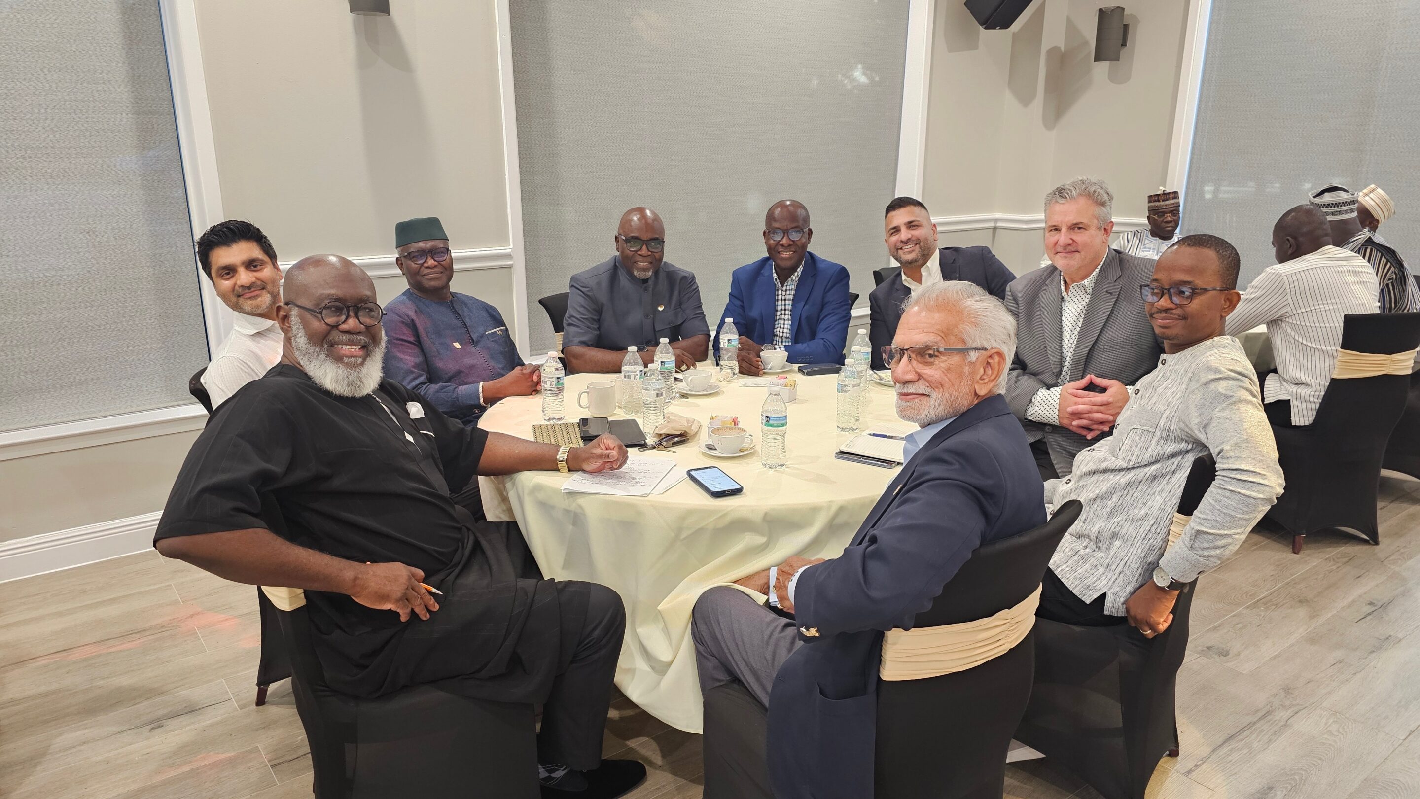 group of people sitting around a table discussing Burkina Faso REE potential