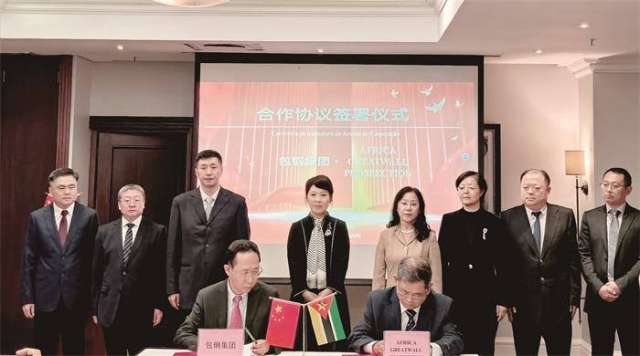 group of people standing in front of a table discussing critical mineral supply chains