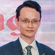 man in a suit and tie posing for a picture with a focus on AI metallurgy