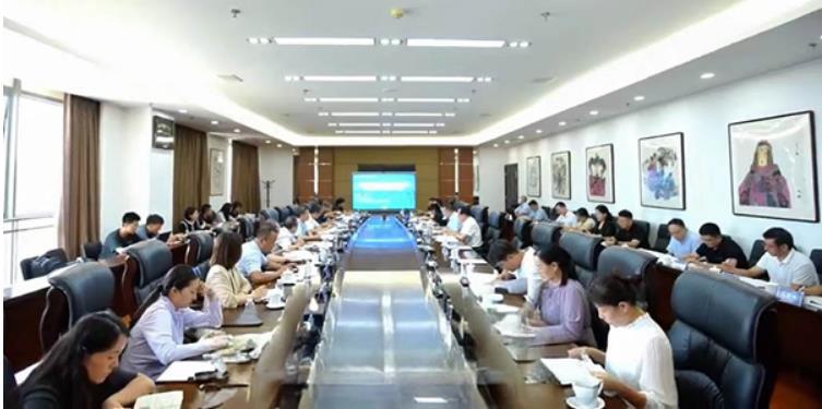 room full of people sitting at desks engaged in discussions about AI mineral exploration