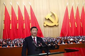 man standing at a podium in front of a crowd of people discussing China rare earth policy