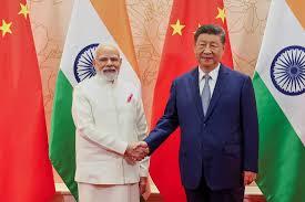 wo men shaking hands in front of flags, symbolizing Sino-Indian geopolitical relations