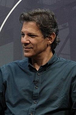 man standing in front of a microphone discussing critical minerals strategy