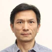 man in a blue and white shirt and tie, resembling humanoid robotics