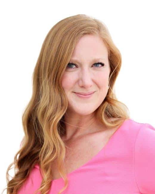 woman in a pink top smiling at the camera