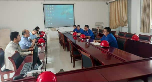 group of people sitting around a conference room discussing rare earth hydrogen storage