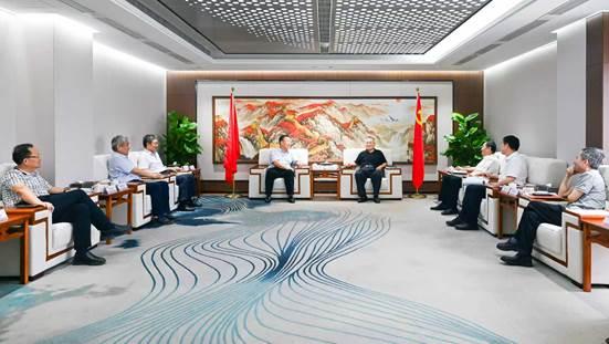 group of people sitting around a conference room discussing rare earth strategy