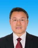 man in a suit and tie standing in front of a blue sky, representing strategic resource innovation