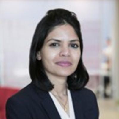 woman in a business suit posing for a picture in connection with the Locksley Resources Columbia University partnership