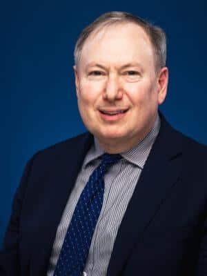 man in a suit and tie posing for a picture related to rare earth subsidies