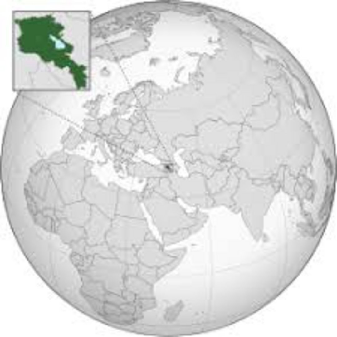 Armenia highlighted in dark green on orthographic globe projection, with inset map detail of Armenian territory including Lak
