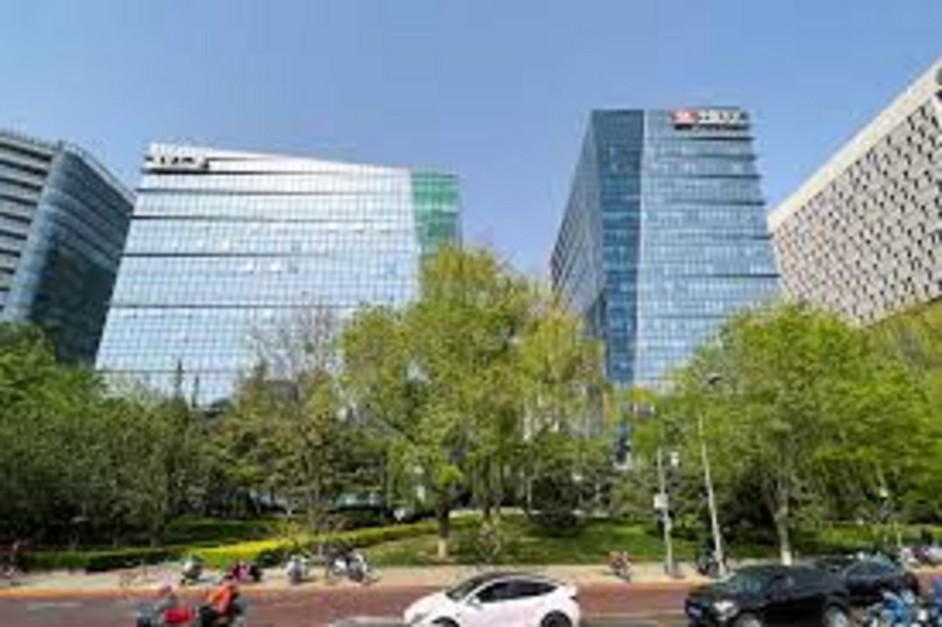 HSBC Bank tower among modern glass office buildings along a tree-lined boulevard in Beijing's central business district on a