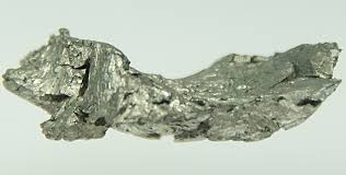 Raw bismuth metal specimen, irregular crystalline chunk with silvery metallic luster and jagged fractured surfaces on white b