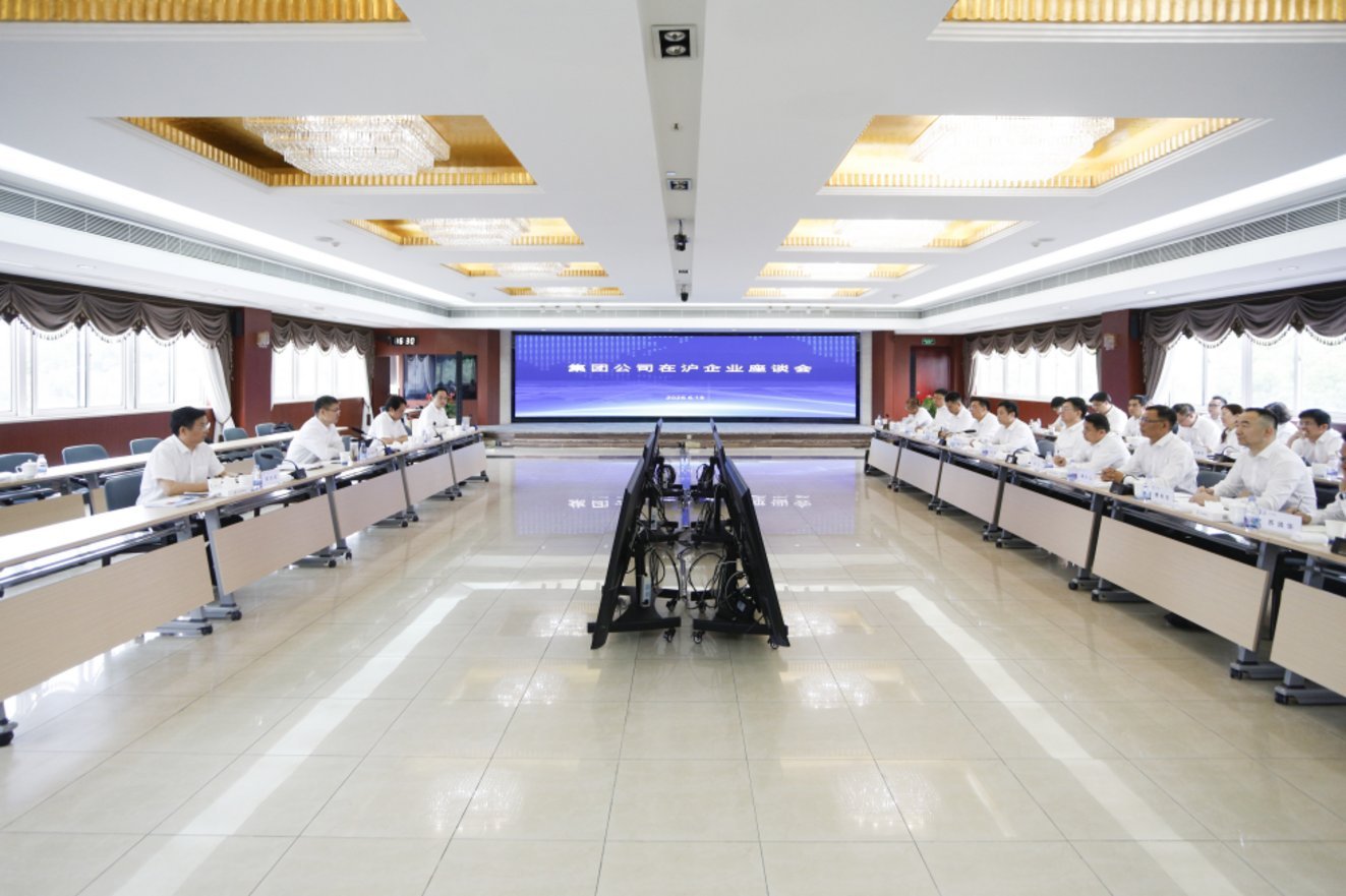 Chinese business executives in white shirts seated at conference tables during Meituan Group Hefei enterprise symposium with