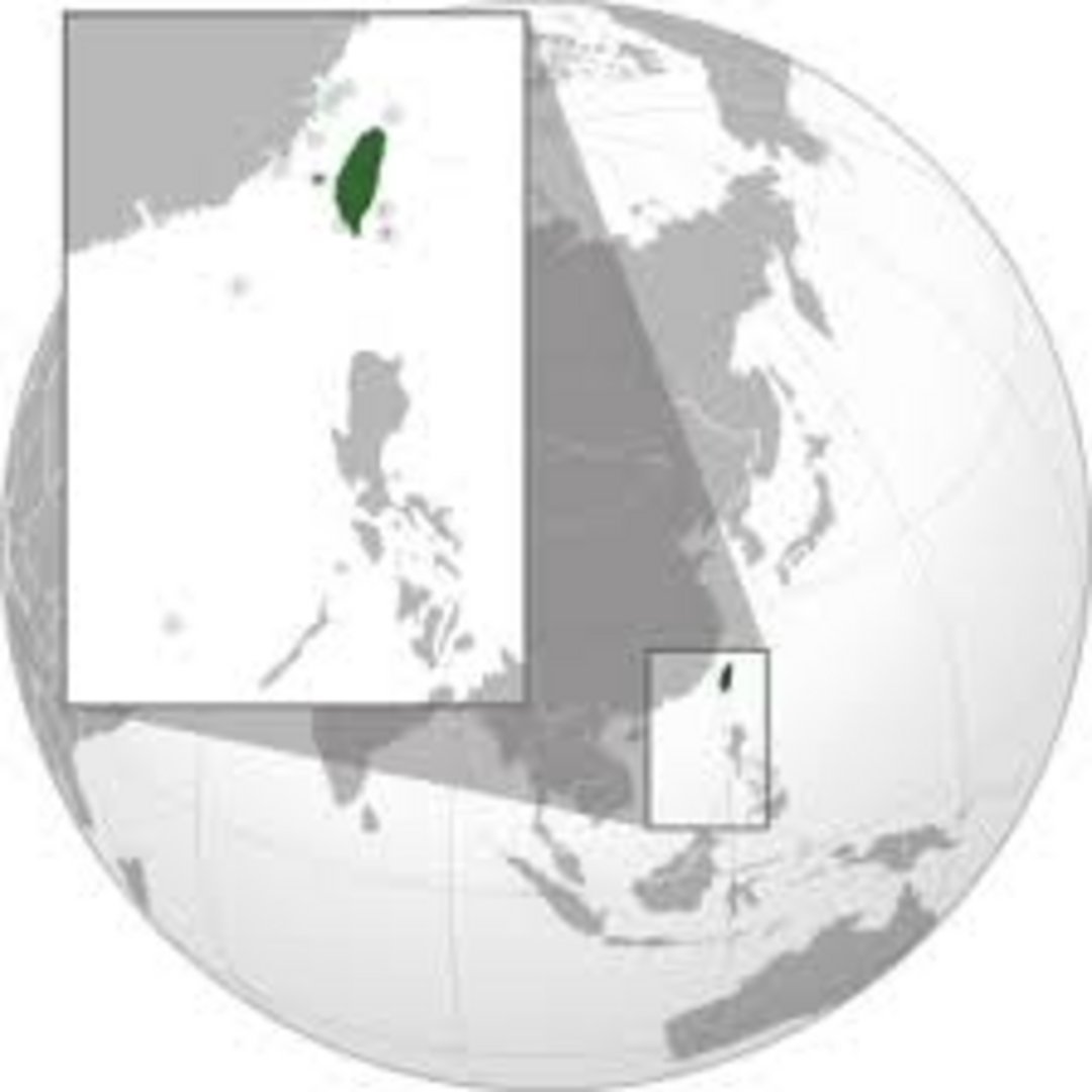 Taiwan highlighted in green on orthographic globe map with inset showing location relative to Philippines and South China Sea