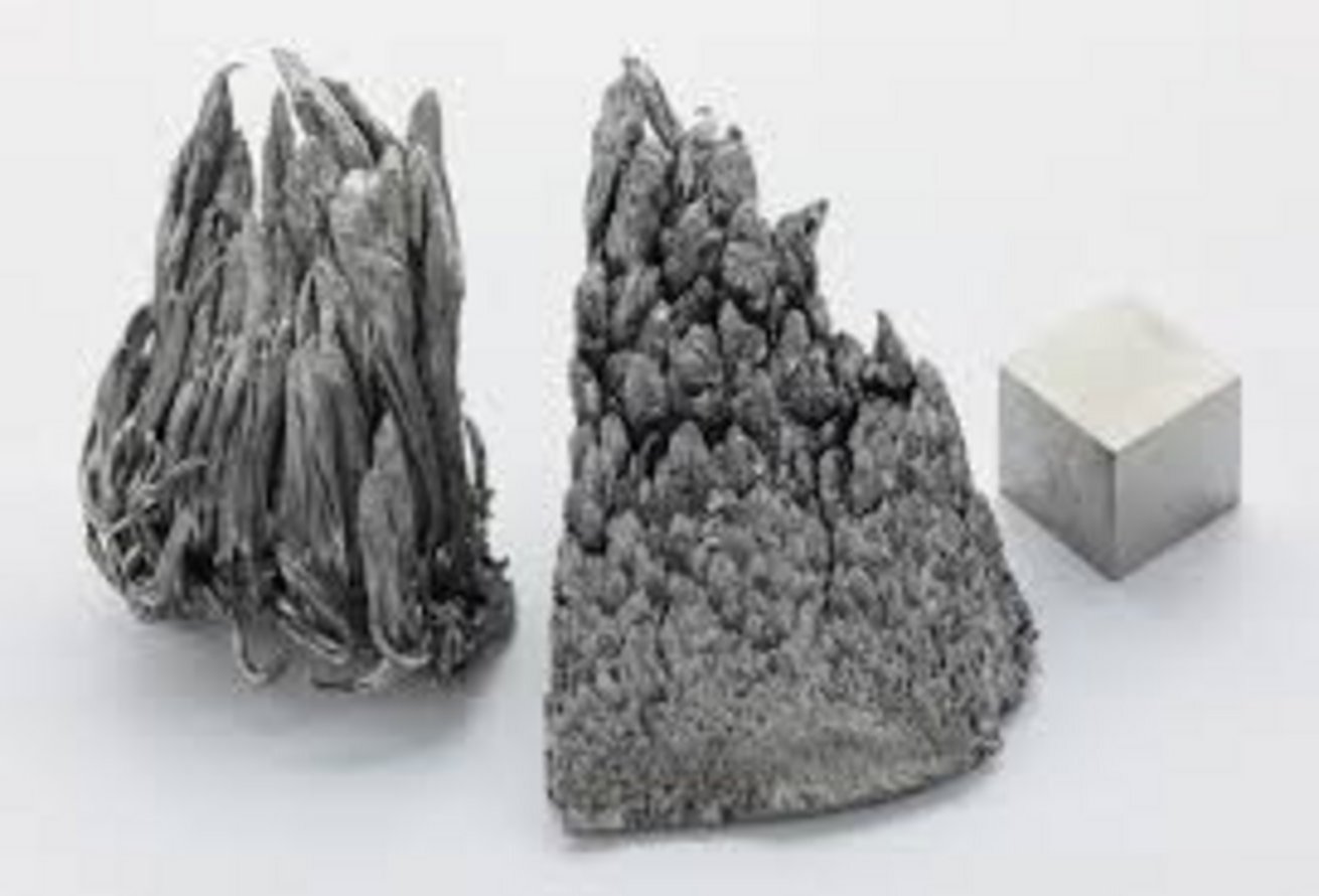 Three forms of pure manganese element: two dendritic crystalline specimens with jagged fractal formations and one smooth poli