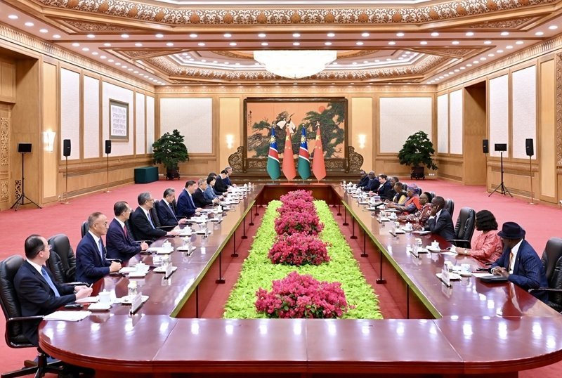 Chinese and Namibian delegations seated at formal negotiating table with Namibian and Chinese flags at Great Hall of the Peop