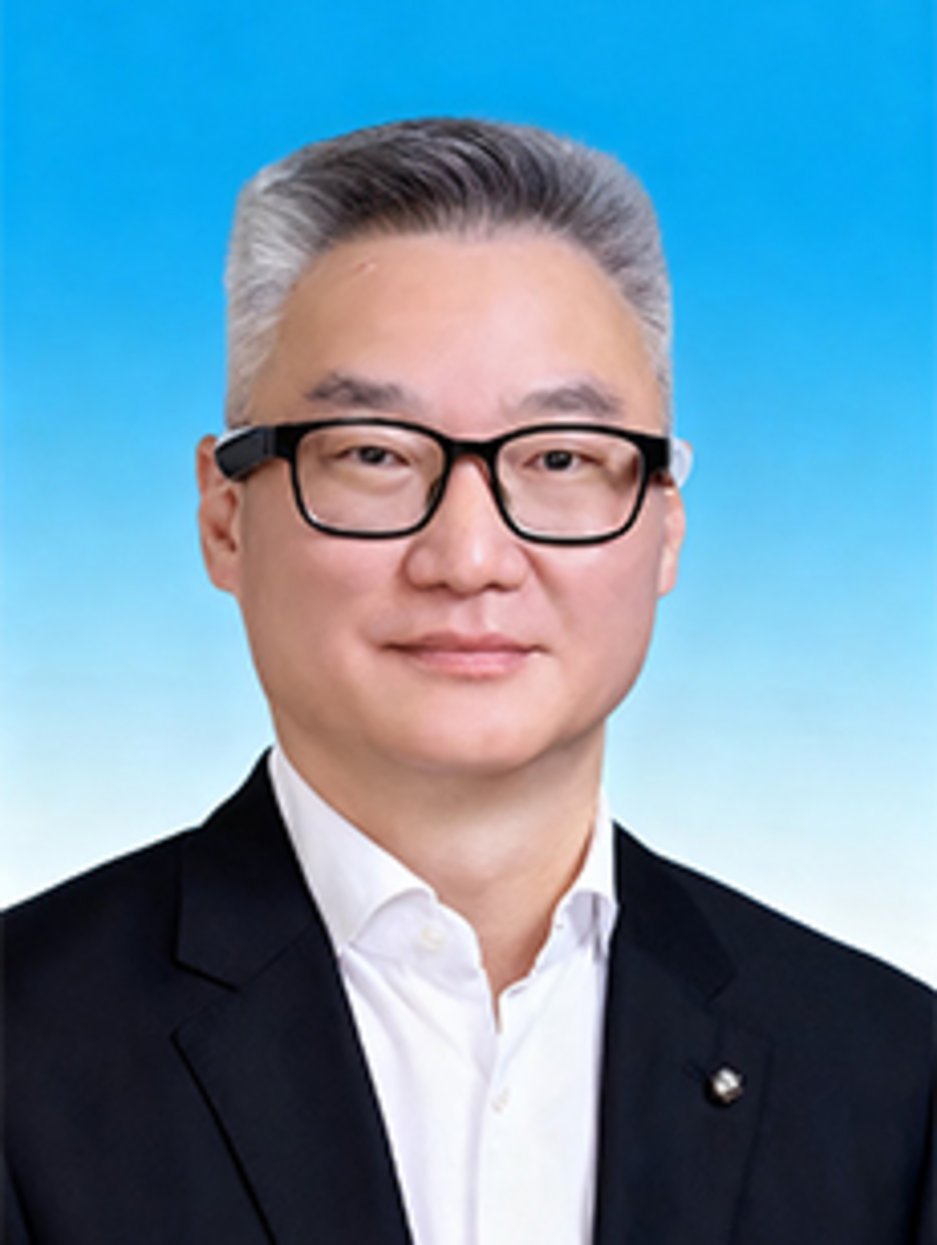 Middle-aged Asian man with silver-gray hair and black rectangular glasses, wearing a dark blazer over white shirt, formal por