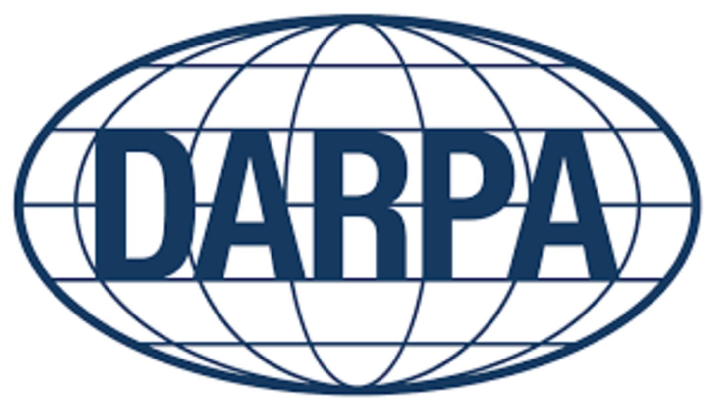 DARPA acronym in bold dark navy blue letters centered on a globe grid oval emblem representing the Defense Advanced Research
