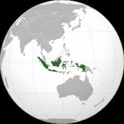 Orthographic globe map highlighting Indonesia in green across Southeast Asian archipelago between Indian Ocean and Pacific Oc