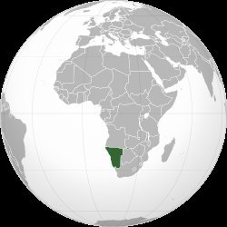 Orthographic globe map with Namibia highlighted in dark green on the southwestern coast of Africa, bordered by Angola, Botswa