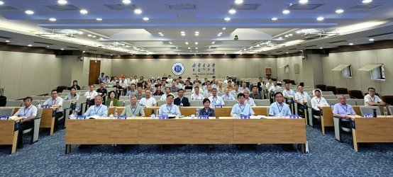 Large group of conference attendees seated in rows at Beijing University of Aeronautics and Astronautics auditorium with inst