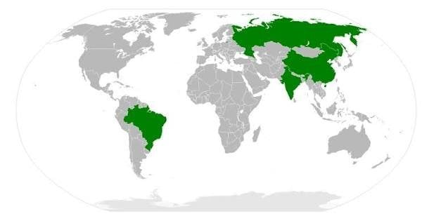 World map with BRICS member nations Brazil, Russia, India, China, and South Africa highlighted in green against gray countrie