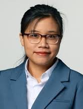 Young Asian woman with glasses and dark hair wearing a teal blazer over white shirt in a formal professional portrait