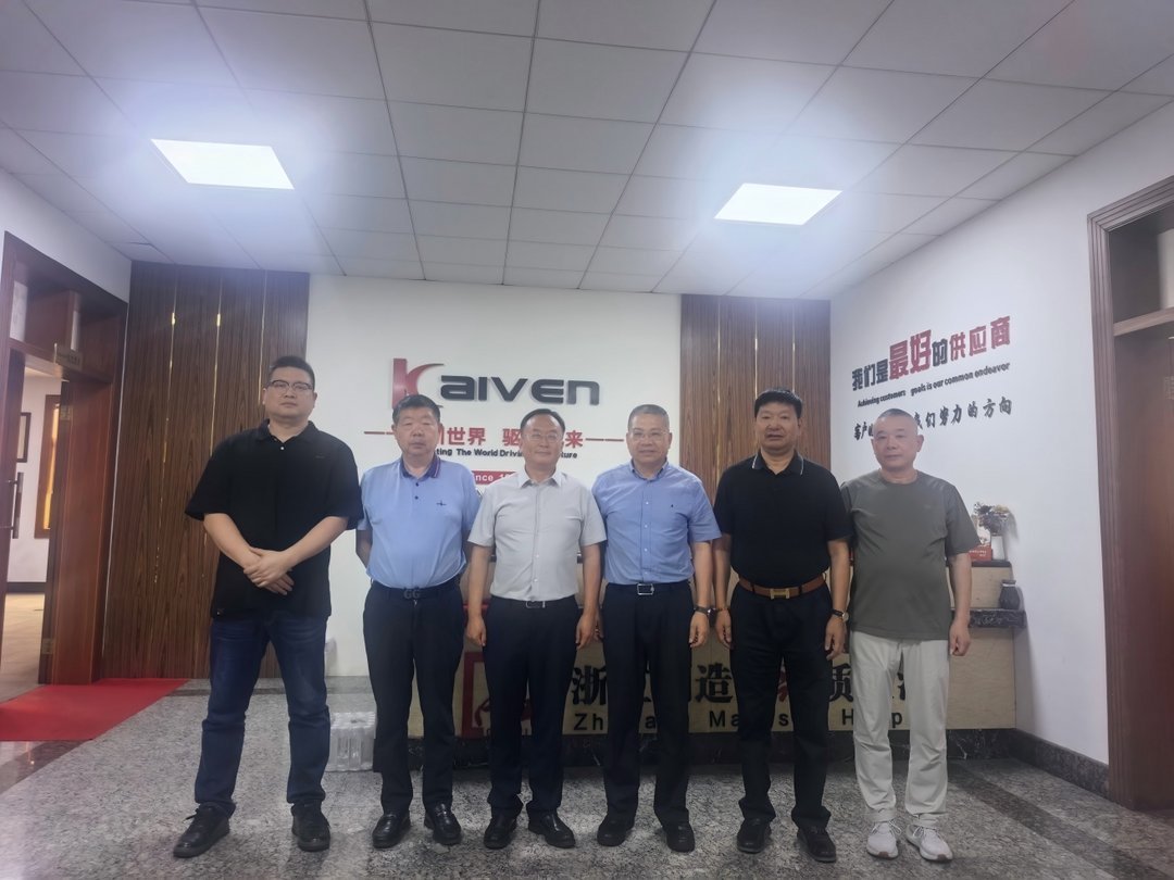 Six male business professionals standing in Kaiven corporate headquarters lobby with branded wall signage in Chinese and Engl