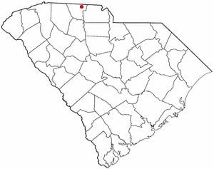 A red dot marking a city location in the northern region of South Carolina on a white outlined county boundary map