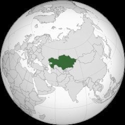 Orthographic globe map with Kazakhstan highlighted in dark green, centered on Central Asia surrounded by Russia China and Mid