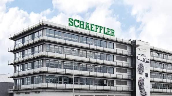 Schaeffler AG multi-story glass and concrete headquarters building with large green rooftop logo sign and automotive product