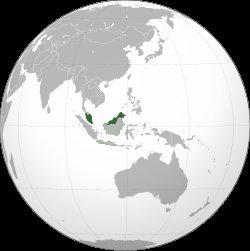 Orthographic globe map highlighting Malaysia in green, spanning Malay Peninsula and northern Borneo, surrounded by Southeast