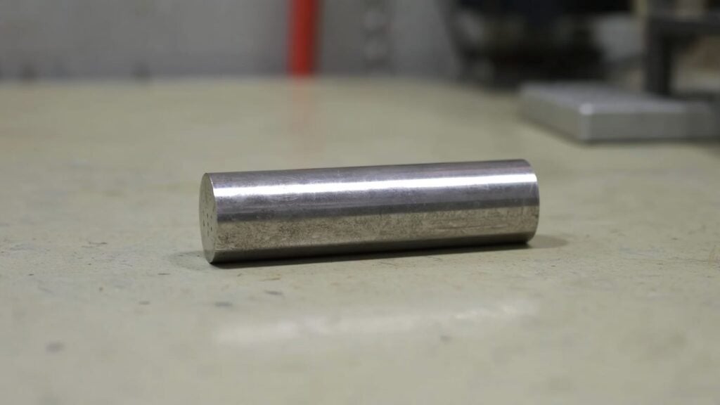 The Strongest Metal on Earth: Why the Answer Depends on What You Measure Strongest metal on earth: polished tungsten metal bar on neutral surface showing gray metallic finish in natural light